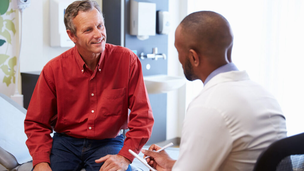 Male Patient and Doctor Discussing Prostate Cancer Screenings Doctor For Blog