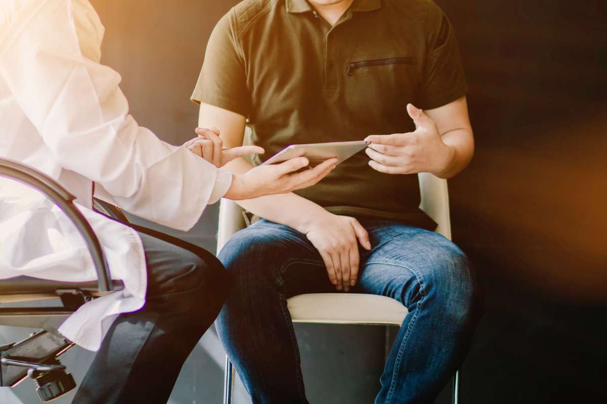 A physician discusses prostate cancer treatment options with a patient.