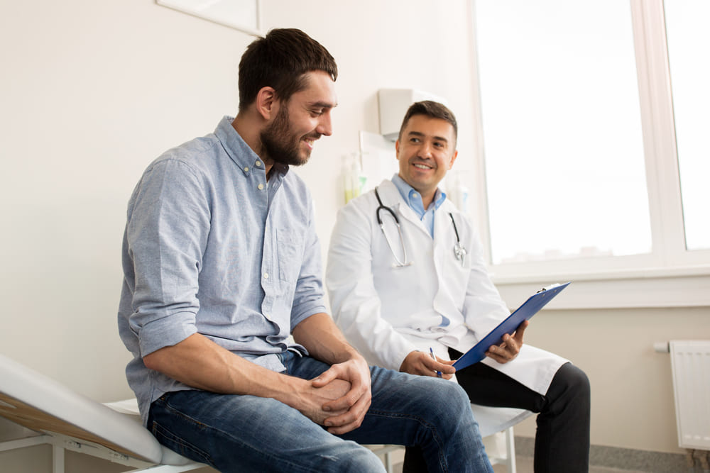 A Physician And Patient Talk About Bph Treatment In An Exam Room