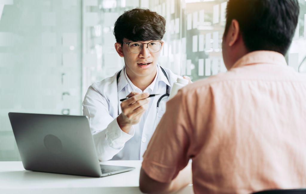 A physician discusses test results with a patient.