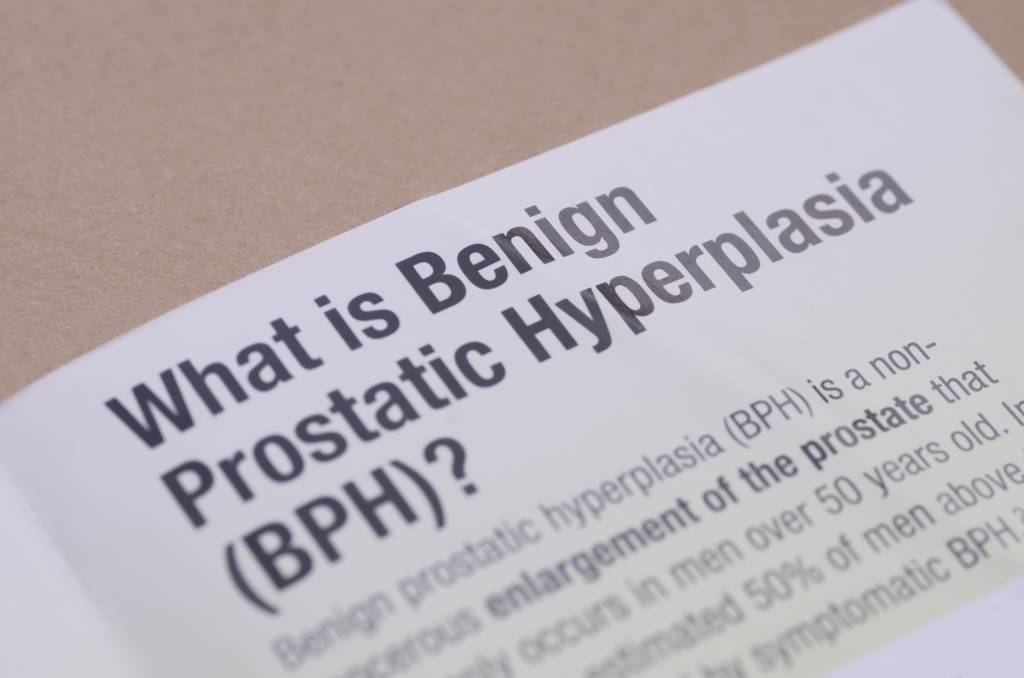 A page in a textbook that starts with the question, “What is benign prostatic hyperplasia?” shown in close-up view.