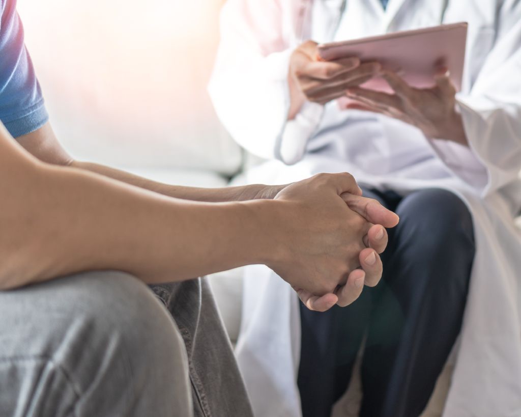 A physician discusses prostate cancer treatment with a patient.