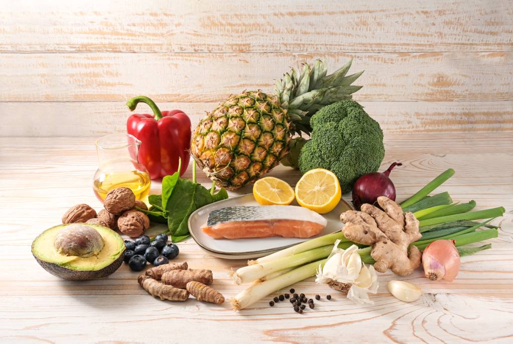 A range of anti-inflammatory foods rest on a wooden table.