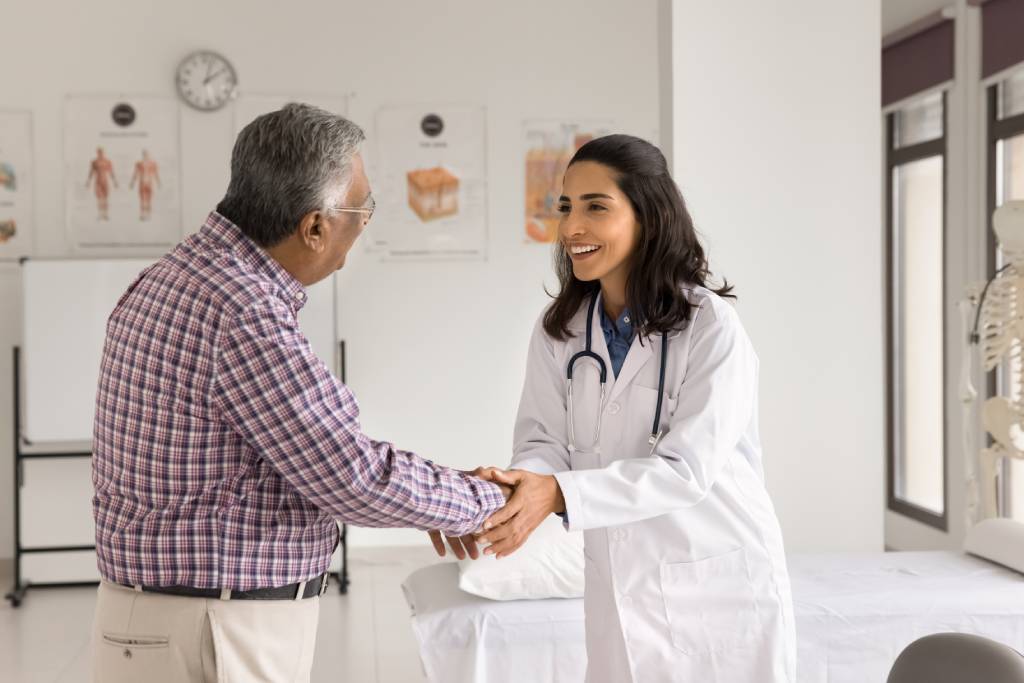 An older man consults with his doctor about prostate cancer treatment.