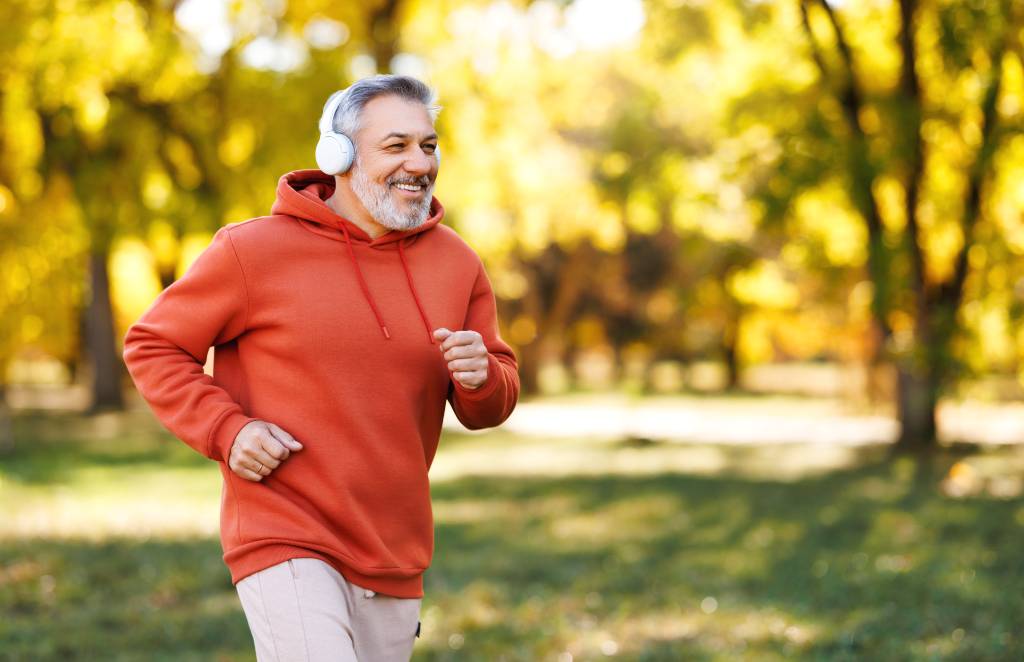 An older man jogs to improve prostate and overall health.