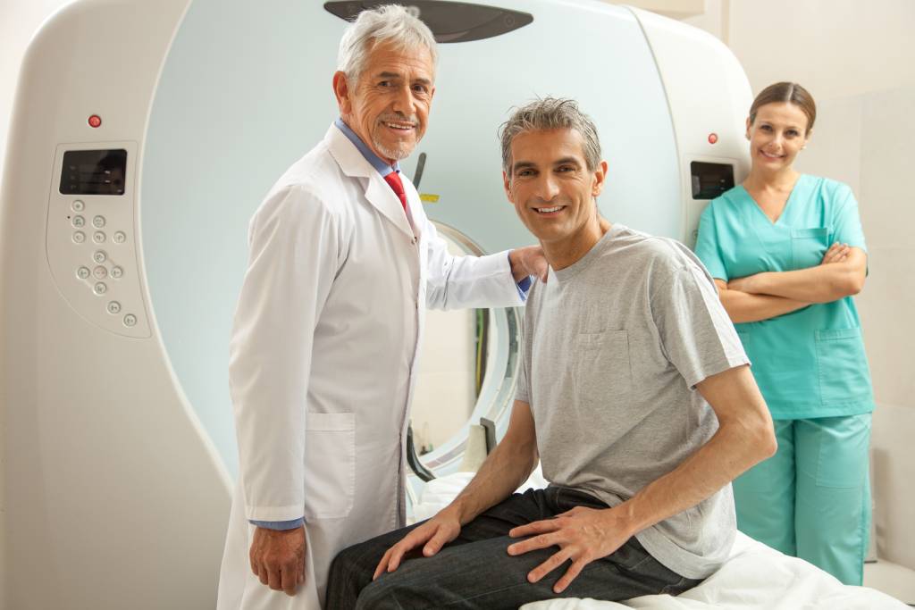 Male patient with physician and nurse about to get an MRI.