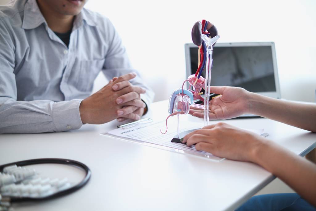 A physician discusses prostate cancer treatment options with a patient.